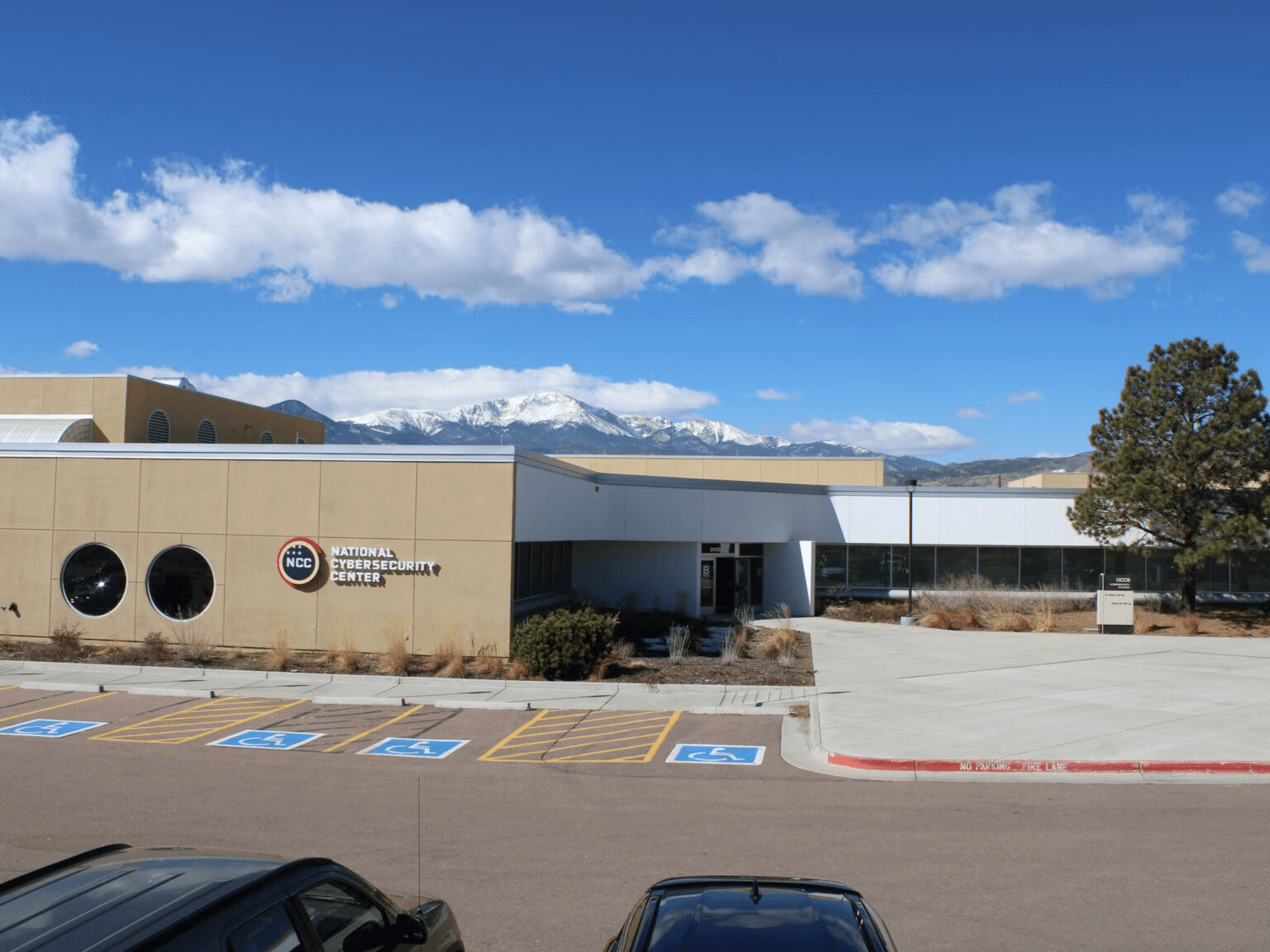The National Cybersecurity Center building in Colorado Springs with Pikes Peak in the background.