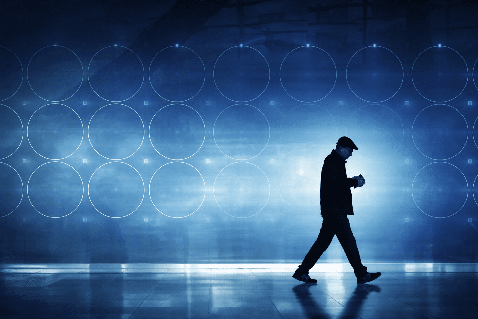 Silhouette of a person walking through a digital cybersecurity environment.