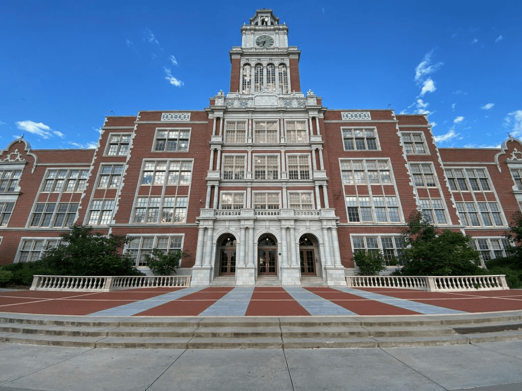 A historic government building with a clock tower under a clear blue sky.